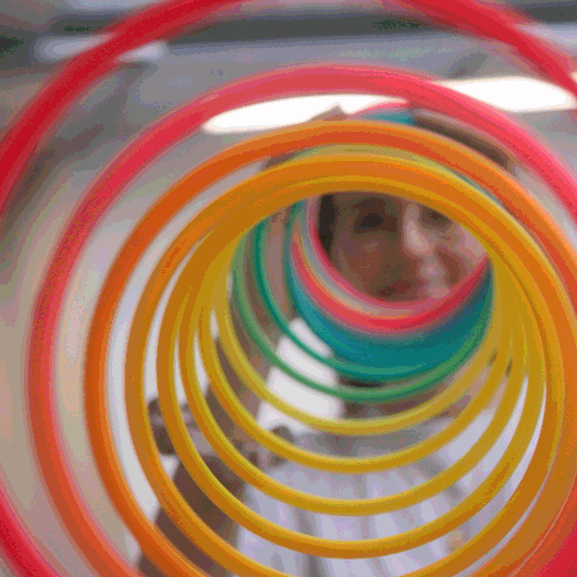 Vibrant red, orange, and green rings, forming a swirling spiral pattern.